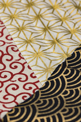Highly detailed all over background texture of traditionals japaneses red, gold and white and black hemp leaves or rainbow  shaped pattern design textile in synthetic fabric.