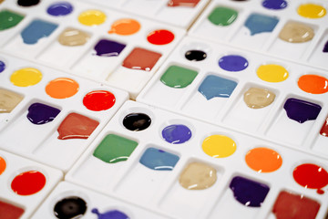 Multi-colored paint in a plastic palette.