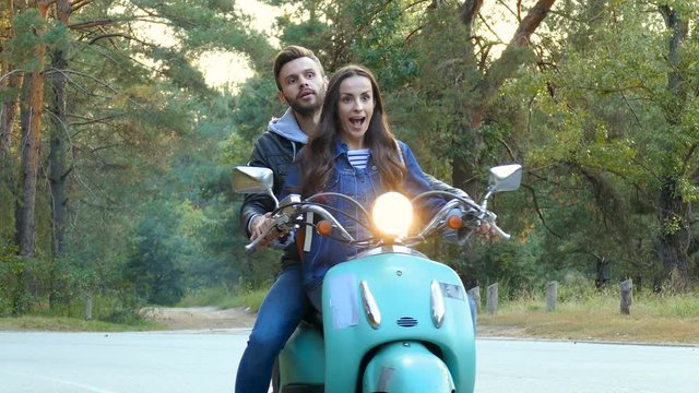 Couple on the scooter. Boyfriend teaching how to drive scooter.