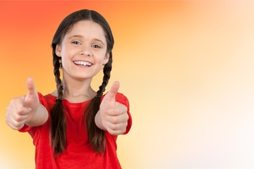 Little student girl showing thumbs up isolated