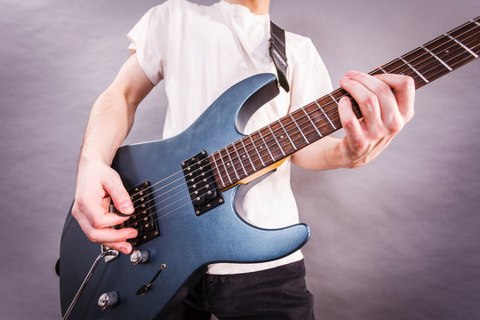 Close up of man playing on electric guitar