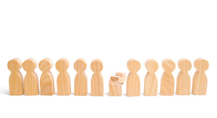 A row of wooden people and a broken figure of a person among them. The concept of a weak link. employee for dismissal. mental health. Did not give up to expectations and did not fulfill the task.