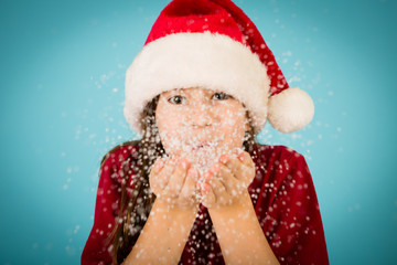 Christmas Girl in Santa Hat, Blowing Snow from Hands
