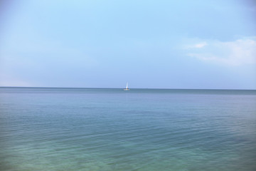 Fototapeta na wymiar beautiful, calm, clean sea. a white ship sails on the sea