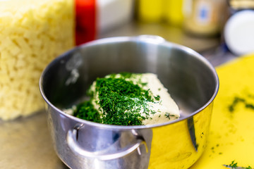 Cutted Dill on Top of The Butter in the Steel Pot