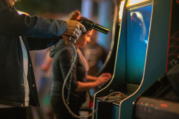 Close upf of man playing arcada with gun