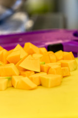 Cutted Pumpkin Pieces on the Yellow Plastic Board