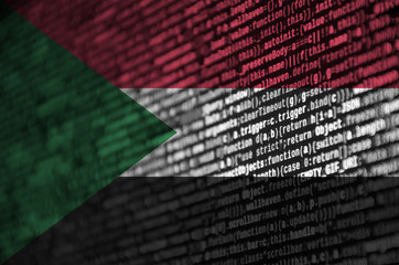 Sudan flag  is depicted on the screen with the program code. The concept of modern technology and...