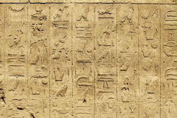 Fototapeta na wymiar Ancient egyptian hieroglyphs carved on the stone wall