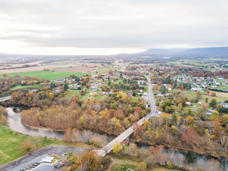 Fototapeta premium Aerial of the small town of Elkton, Virginia in the Shenandoah Valley with Mountains in the Distance