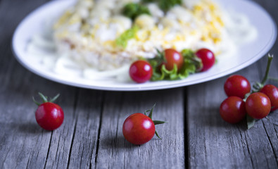 mushroom salad with tomatoes on wooden background