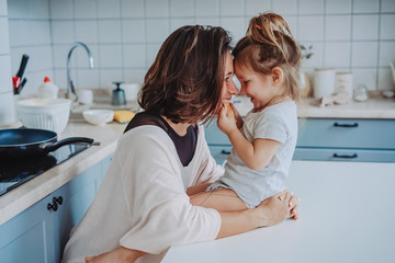 Mom and little daughter having fun together