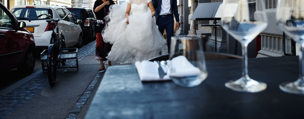 young wedding couple holding hands, groom and bride