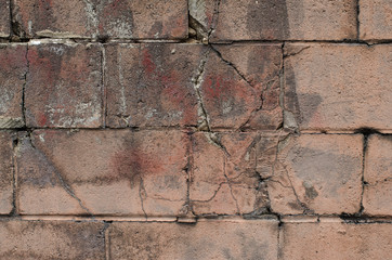 Pink cinderblock wall painted and cracked