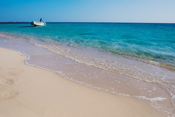 Beautiful seaside horizont with sand and blue water waves