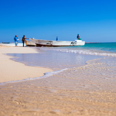 Beautiful seaside horizont with sand and blue water waves