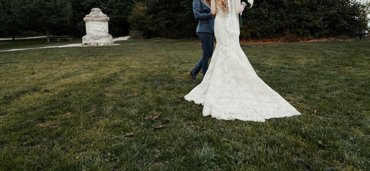 young wedding couple holding hands, groom and bride