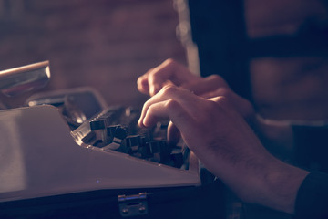Journalist typing on an antique vintage typewriter machine