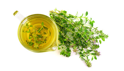 Fresh Wild Thyme Tea in a Glass with a Bunch of Thyme Herb. Also Tymus Vulgaris, Common, German or...