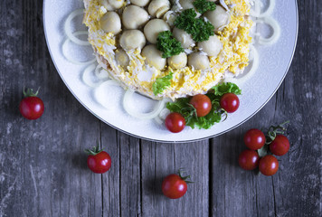 mushroom salad with tomatoes on wooden background