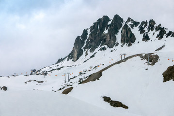 High alpine summit and distant chairlift in European ski resort