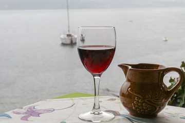 a glass home made red wine with the sea background