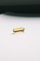 Fish oil capsule on gray background