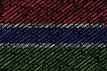Gambia flag  is depicted on the screen with the program code. The concept of modern technology and...