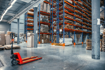 Large Logistics hangar warehouse with lots shelves or racks with pallets of goods. Industrial shipping and cargo delivery distribution