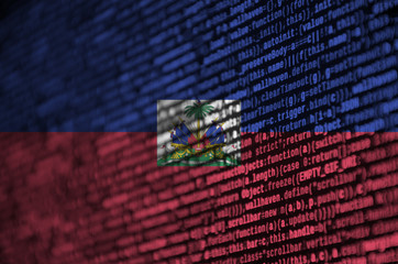 Haiti flag  is depicted on the screen with the program code. The concept of modern technology and...