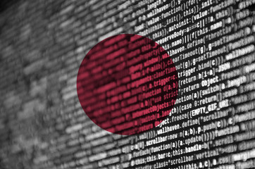 Japan flag  is depicted on the screen with the program code. The concept of modern technology and...
