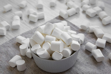 Fluffy white marshmallows in a bowl, side view. Closeup.