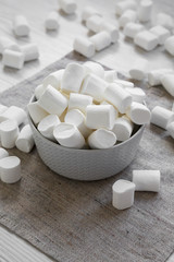 Sweet white marshmallows in a bowl, side view. Close-up.