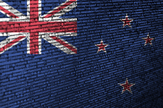 New Zealand flag  is depicted on the screen with the program code. The concept of modern technology and site development - Powered by Adobe