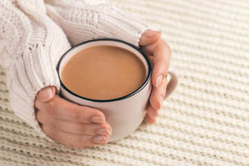 Female hands holding cup of hot cocoa