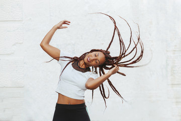 black woman moving with rhythm her long braids