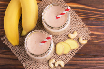 Banana and almond smoothie with ginger in glass jars