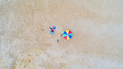 Aerial view of alone colorful umbrella on the beach. Holiday concept top view.