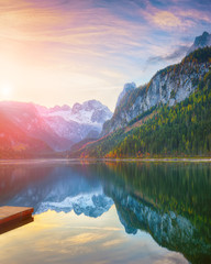 autumn scenery with Dachstein mountain summit reflecting in crystal clear Gosausee mountain lake