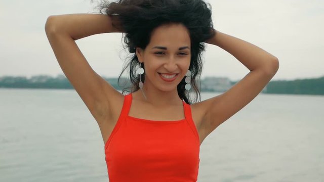 Beautiful woman dancer Kizomba and Bachata outdoors. mixed race woman in red dress