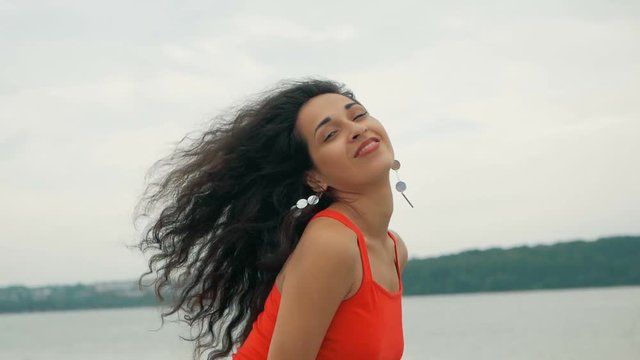 Beautiful woman dancer Kizomba and Bachata outdoors. mixed race woman in red dress