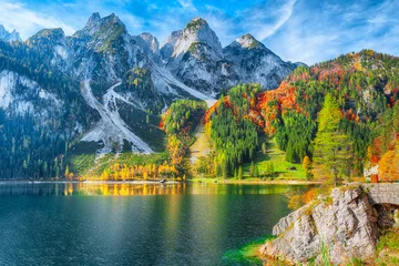 Wall murals Lake / Pond autumn scenery with Dachstein mountain summit reflecting in crystal clear Gosausee mountain lake