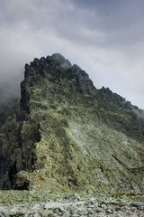 Rocky mountain summit between clouds