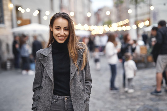 portrait of young beautiful fashionable brunette woman posing in street at autumn.