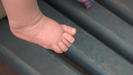 Bare leg of infant baby. Tiny leg of little baby girl or boy. Tips to young parents.