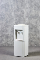 White water cooler gallon in office against gray textured wall background. International Exhibition...