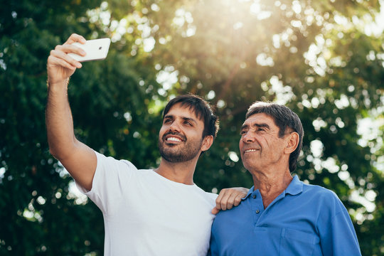 Selfie Portrait Of Father And Adult Son Outdoor