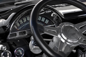 Black vintage car interior dashboard and steering wheel 