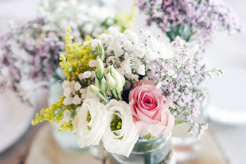 Obraz premium rustic romantic pastel flower arrangement decoration on wedding table.