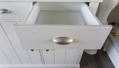 Empty open modern white wooden drawer with nothing inside so empty space to put whatever you like